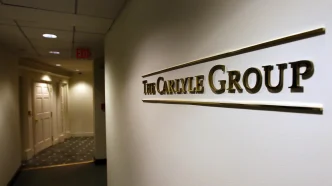 Hallway of an office building with a wall sign reading The Carlyle Group
