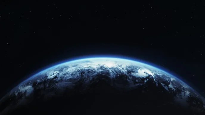 Earth seen from space with a bright blue atmosphere rim against a starry black sky