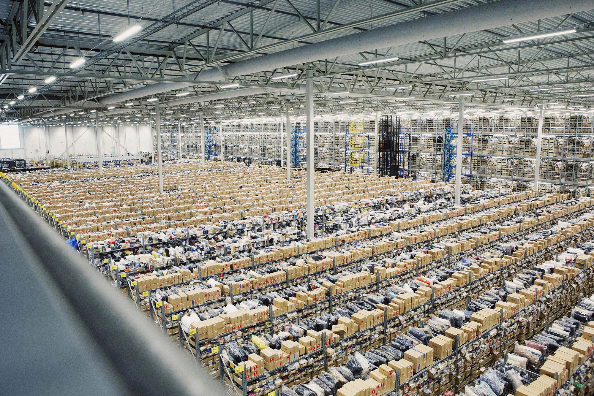 A large warehouse sorting facility with rows of packages
