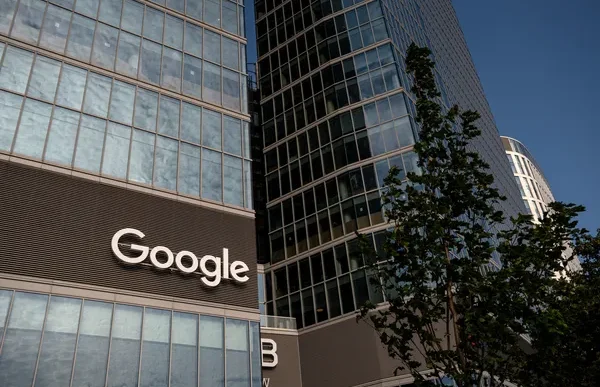 Google logo on the exterior of a glass office building