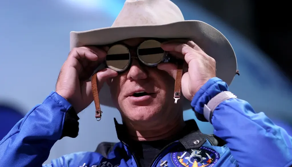 Jeff Bezos wearing a flight suit and hat