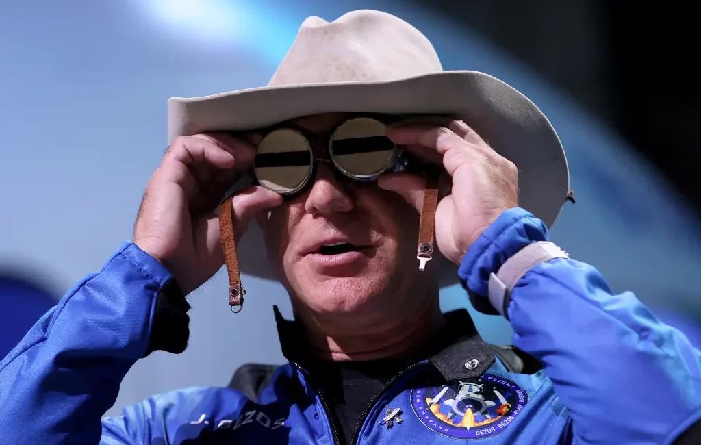 Jeff Bezos wearing a flight suit and hat