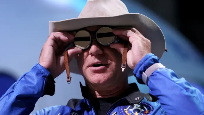 Jeff Bezos wearing a flight suit and hat