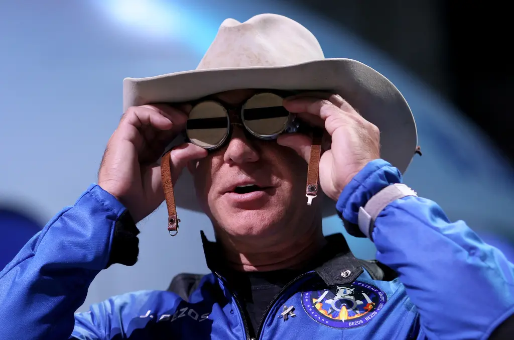 Jeff Bezos wearing a flight suit and hat